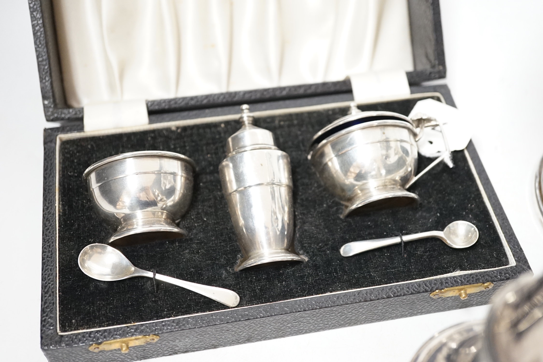 A modern silver baluster sugar caster, Birmingham, 1972, 17.5cm, a cased silver three piece condiment set an a George V silver tazza, weighted.